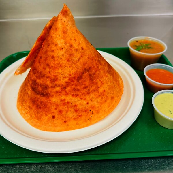 A crisp dosa served with chutneys
