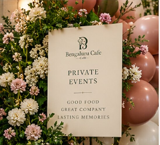 A Bengaluru Cafe Private Events sign among flowers and balloons